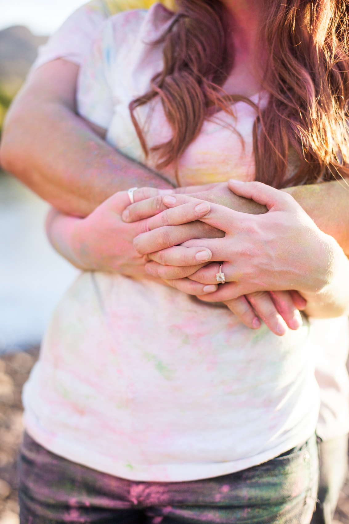 couple holding each other after a color fight with vintage engagement ring