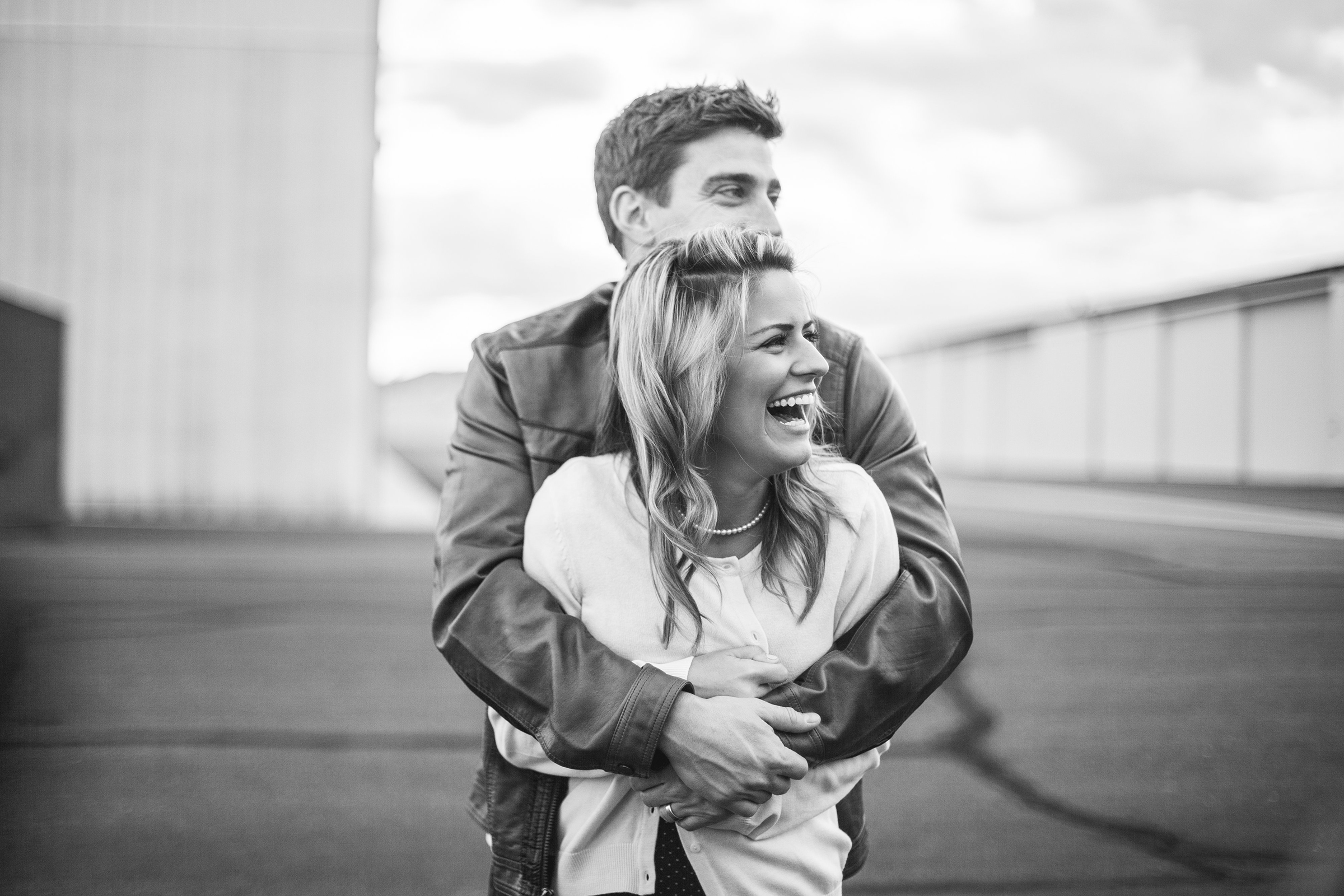 black and white picture of vintage styled couple hugging and smiling