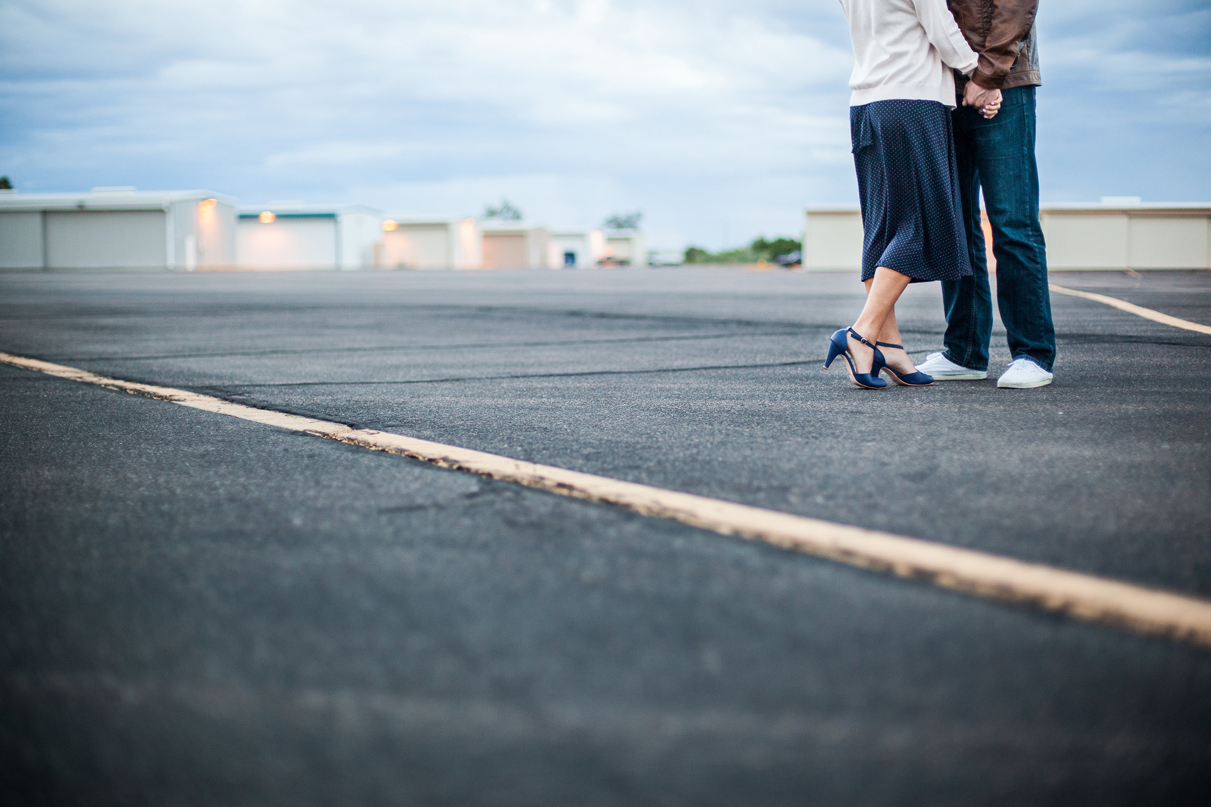 vintage styled couple in airplane hangar alley with vintage shoes