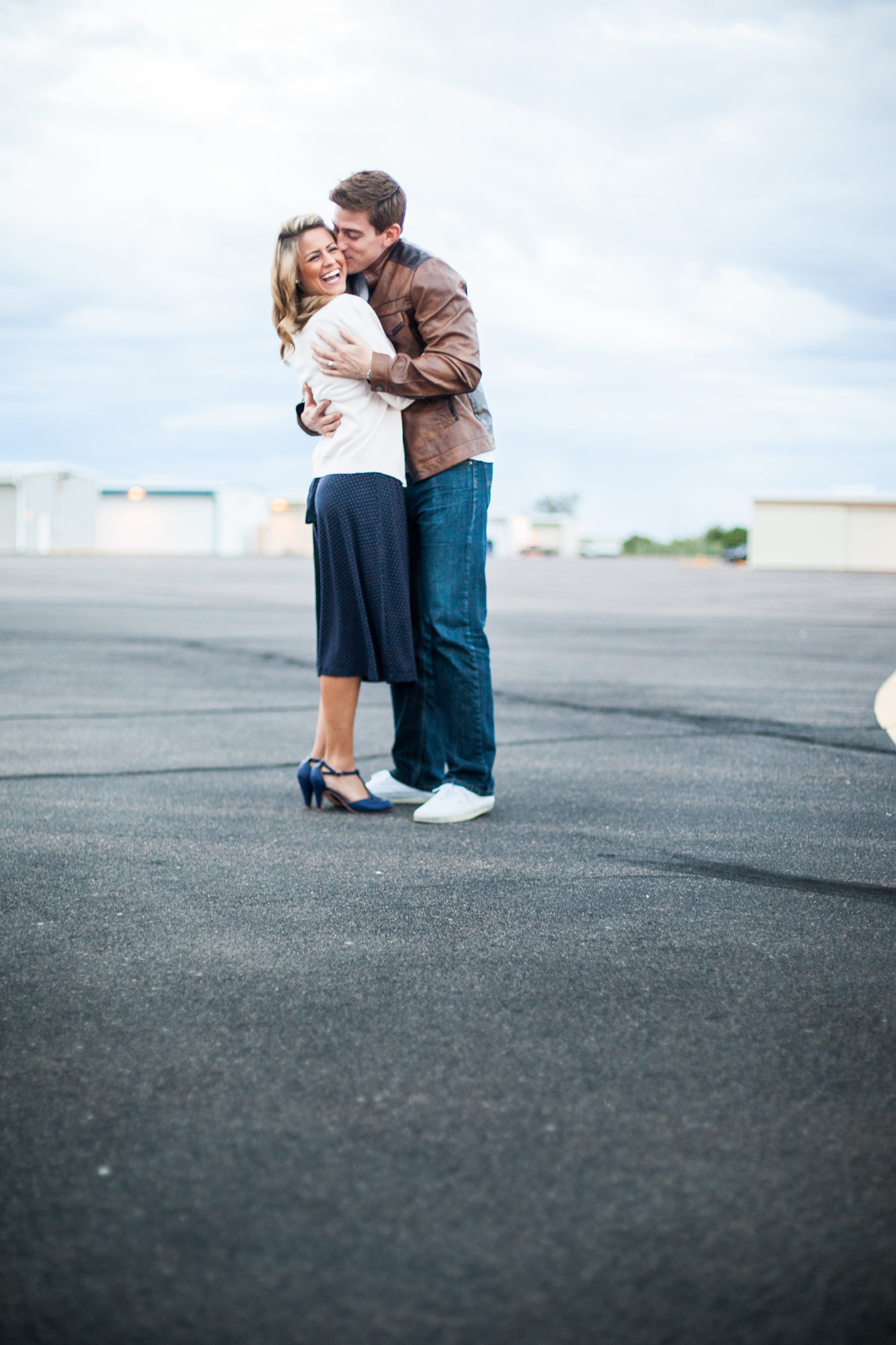 vintage styled couple in airplane hangar alley