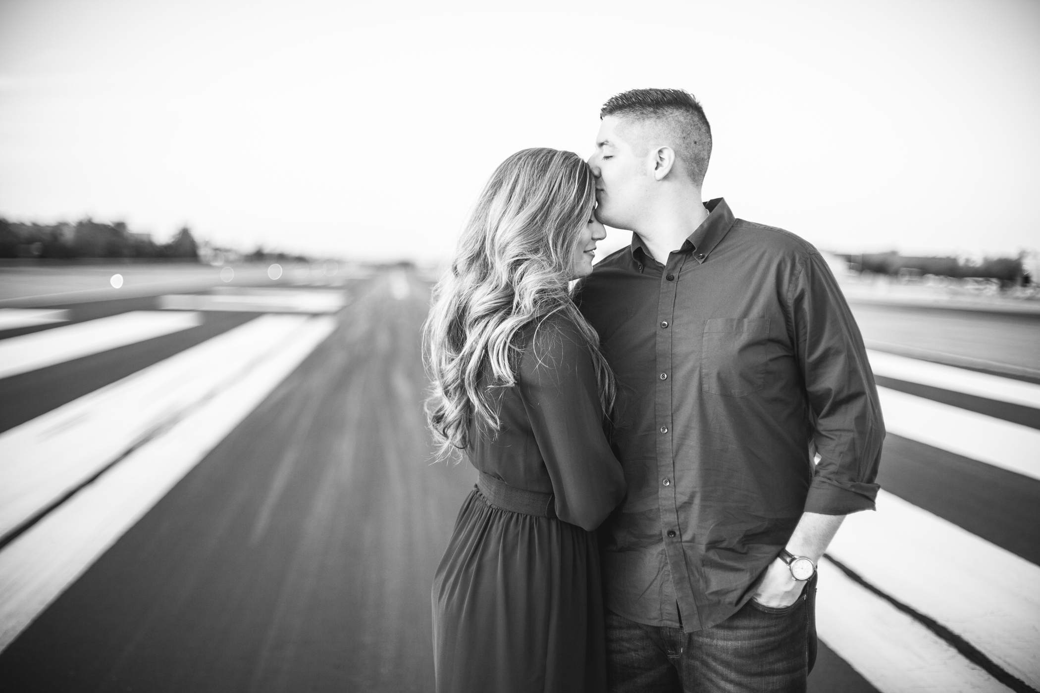 airport engagement pictures on tarmac