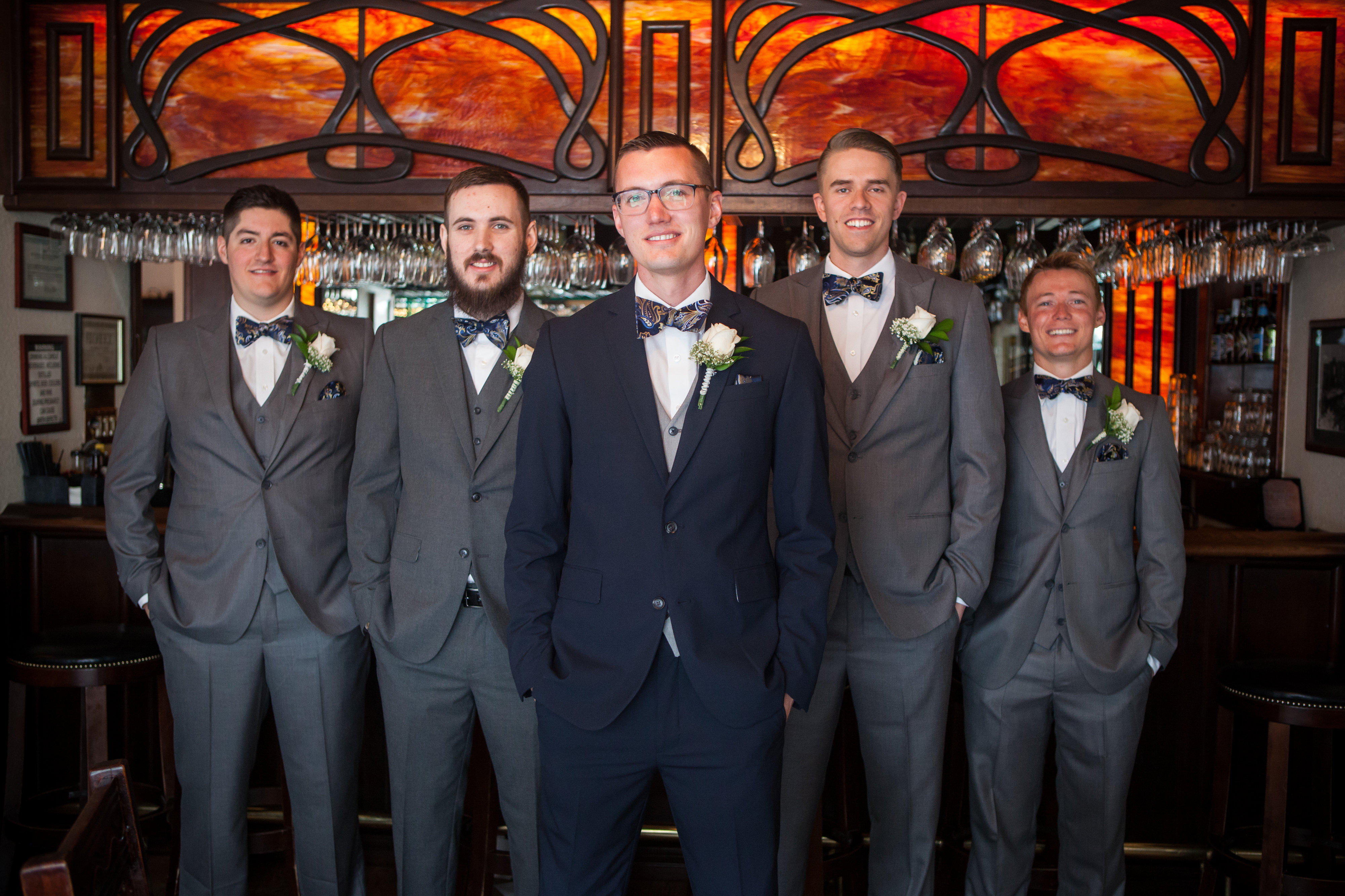 navy blue grooms suit with grey groomsmen suits
