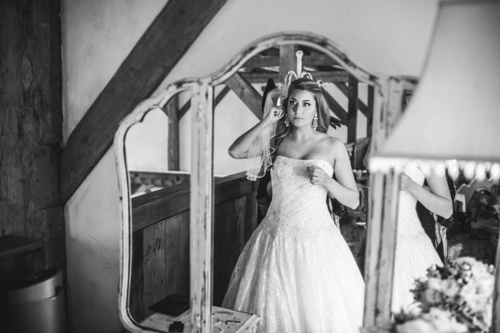 bride getting ready in the mirror