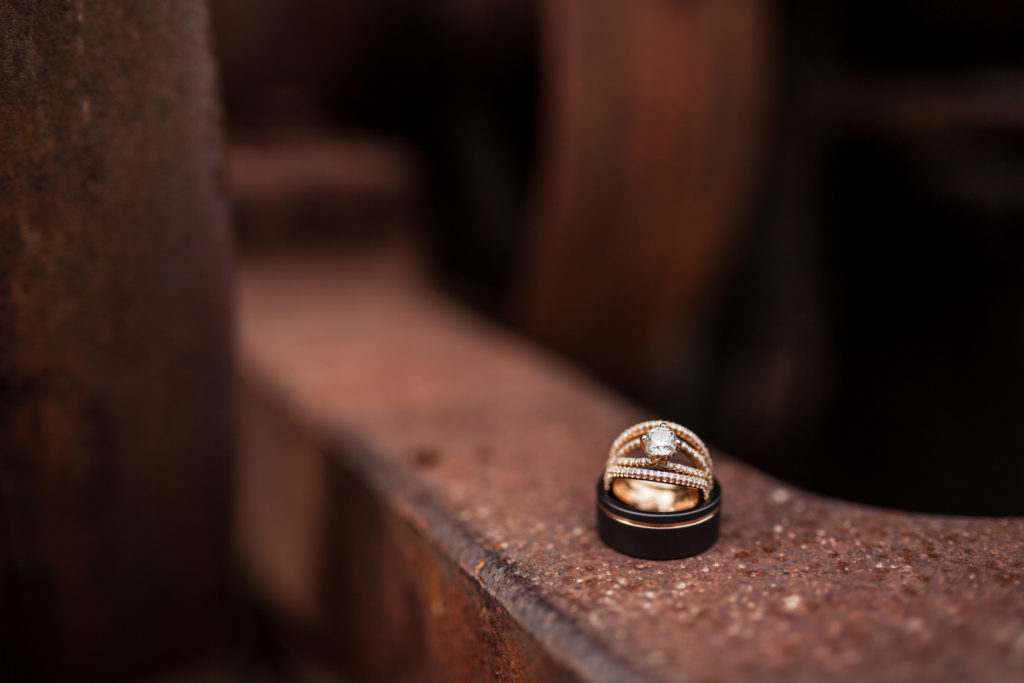rose gold diamond ring with matching rose gold wedding bands on rustic old mill