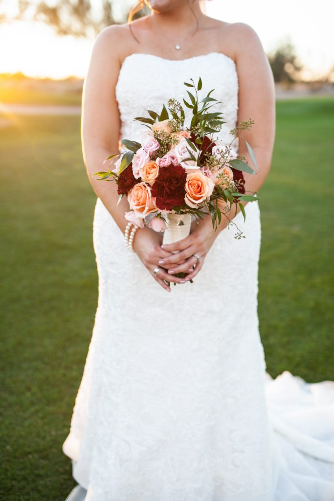 romantic sweetheart sheath wedding dress with jeweled sash in an arizona desert wedding