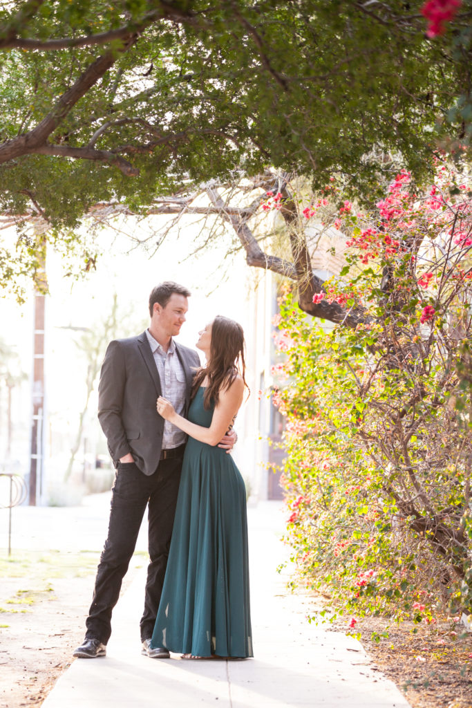 downtown phoenix engagement photos engagement pictures engagement photographer long flowy green dress from lulus for engagement session in golden hour light