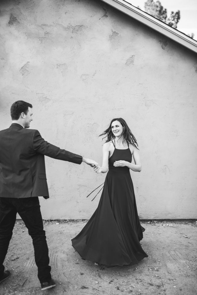 downtown phoenix engagement photos engagement pictures engagement photographer long flowy green dress from lulus for engagement session with gray background dancing couple engagement pictures inspiration black and white