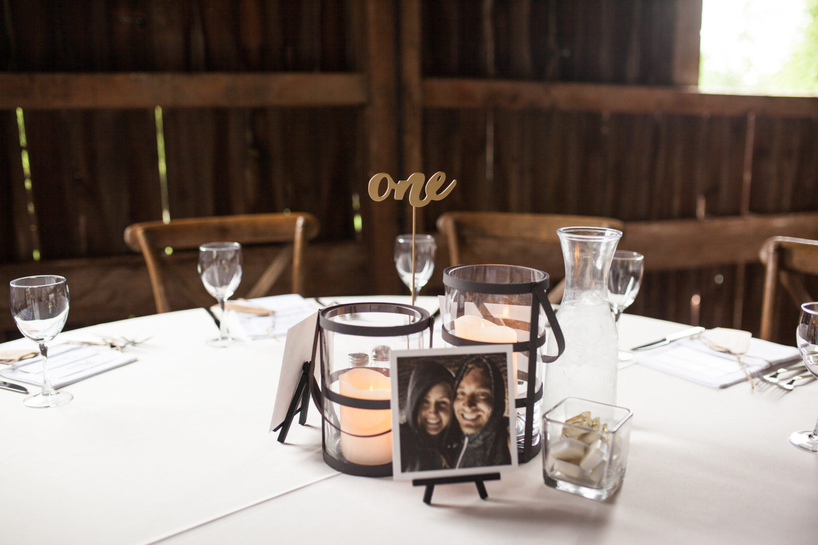 wedding reception in the barn of The Farm at Dover tablescapes with unqiue table numbers