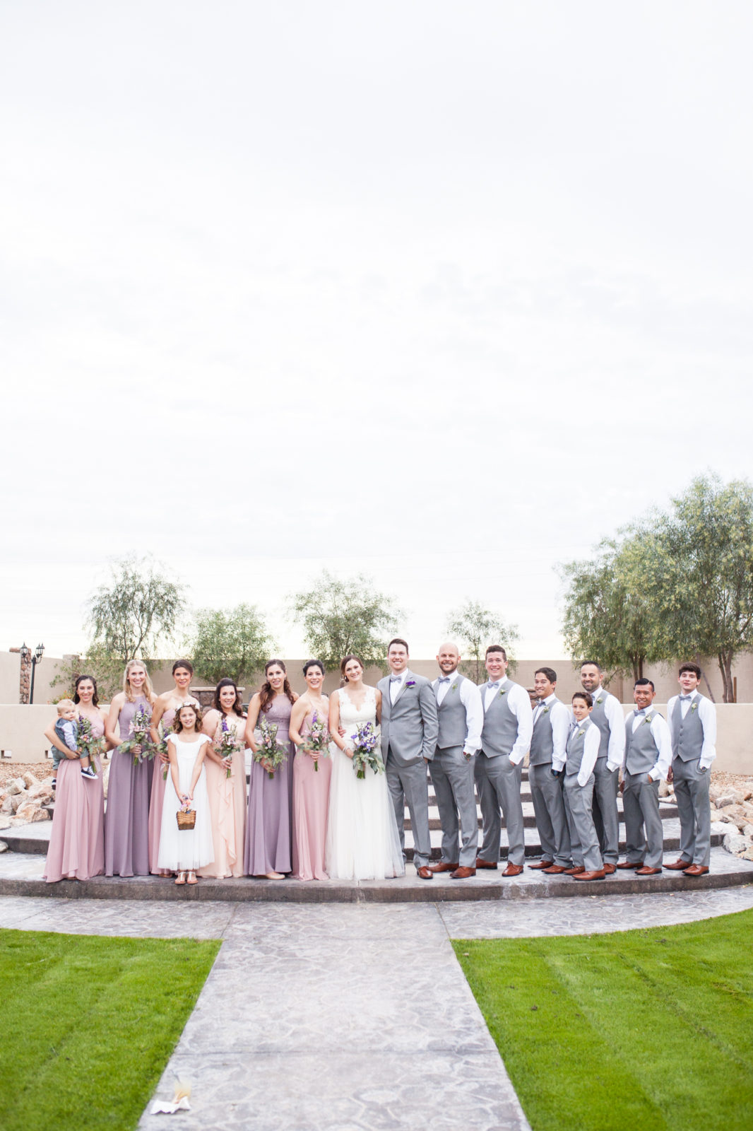 wedding party grey suits and pink and purple bridesmaids dresses
