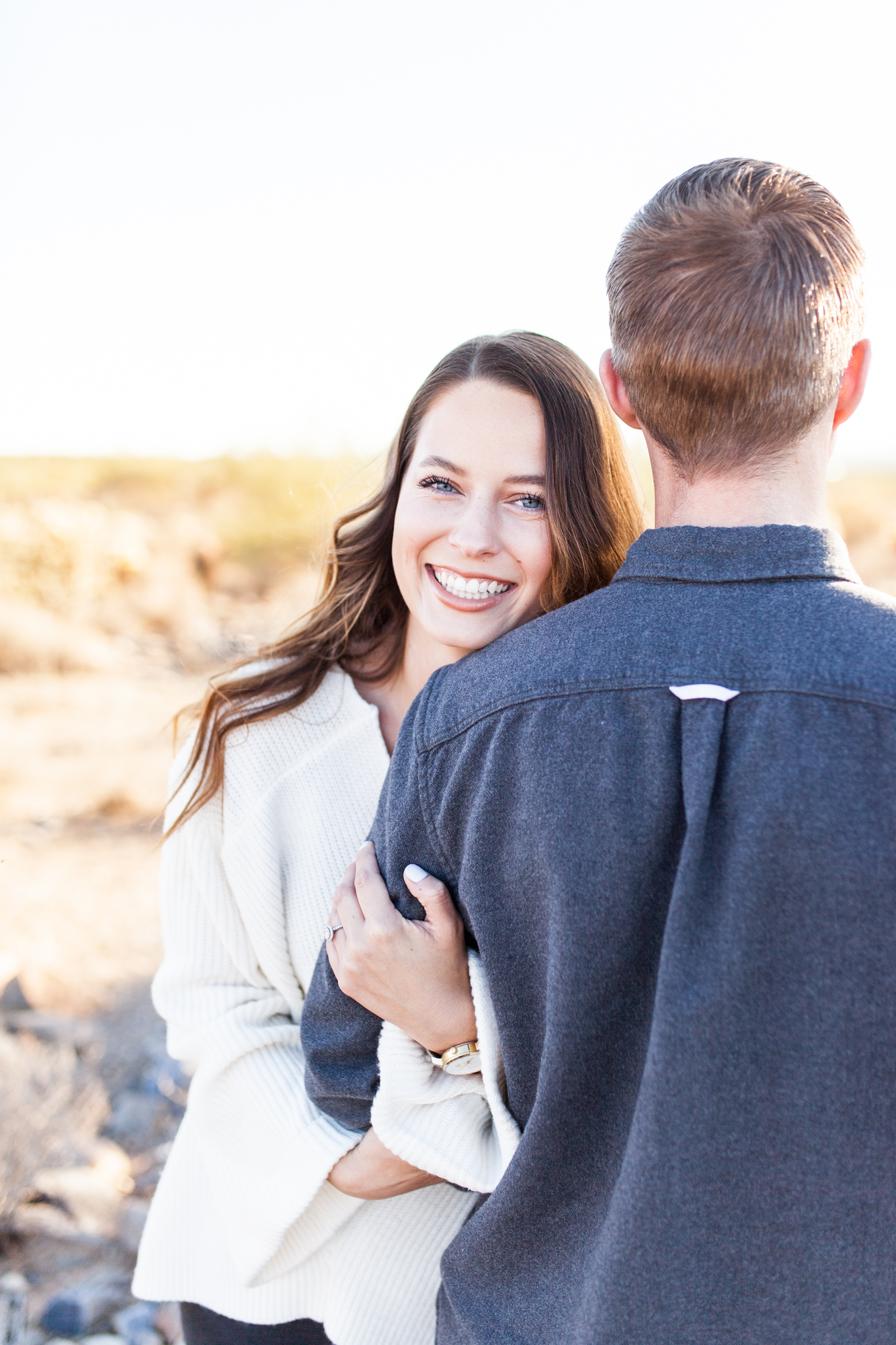 smiling engagement pictures in the desert