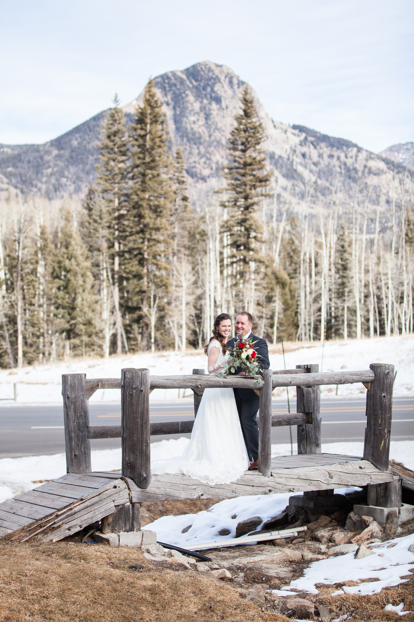 Durango, Colorado Winter Wedding, bride and groom kissing on a bridge