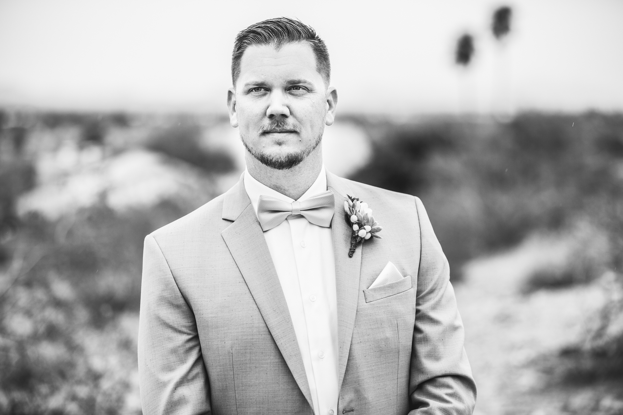 groom in gray suit black and white
