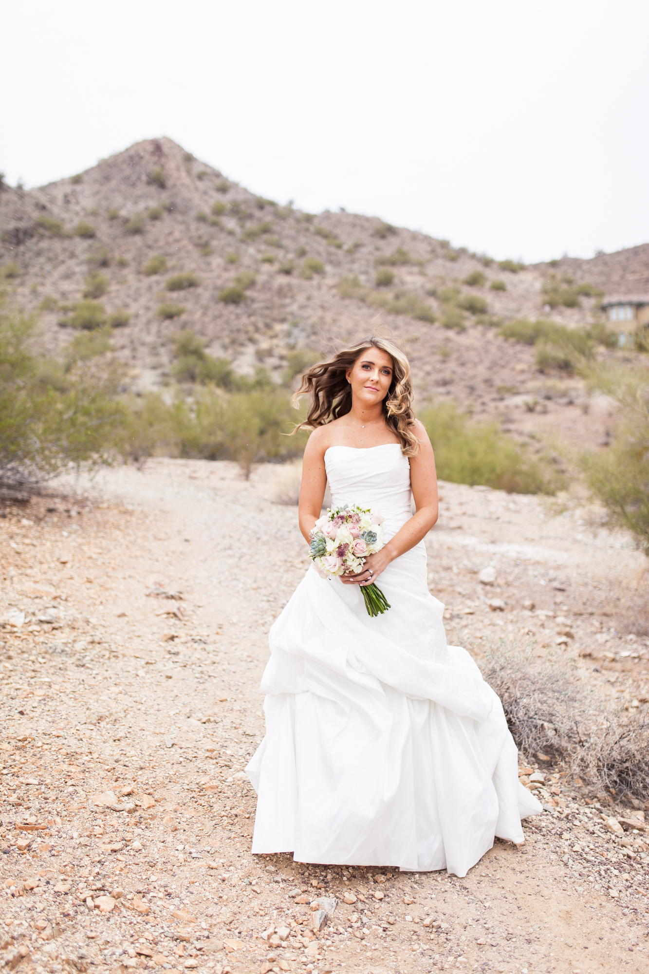 bride with bouquet on rainy phoenix desert wedding day