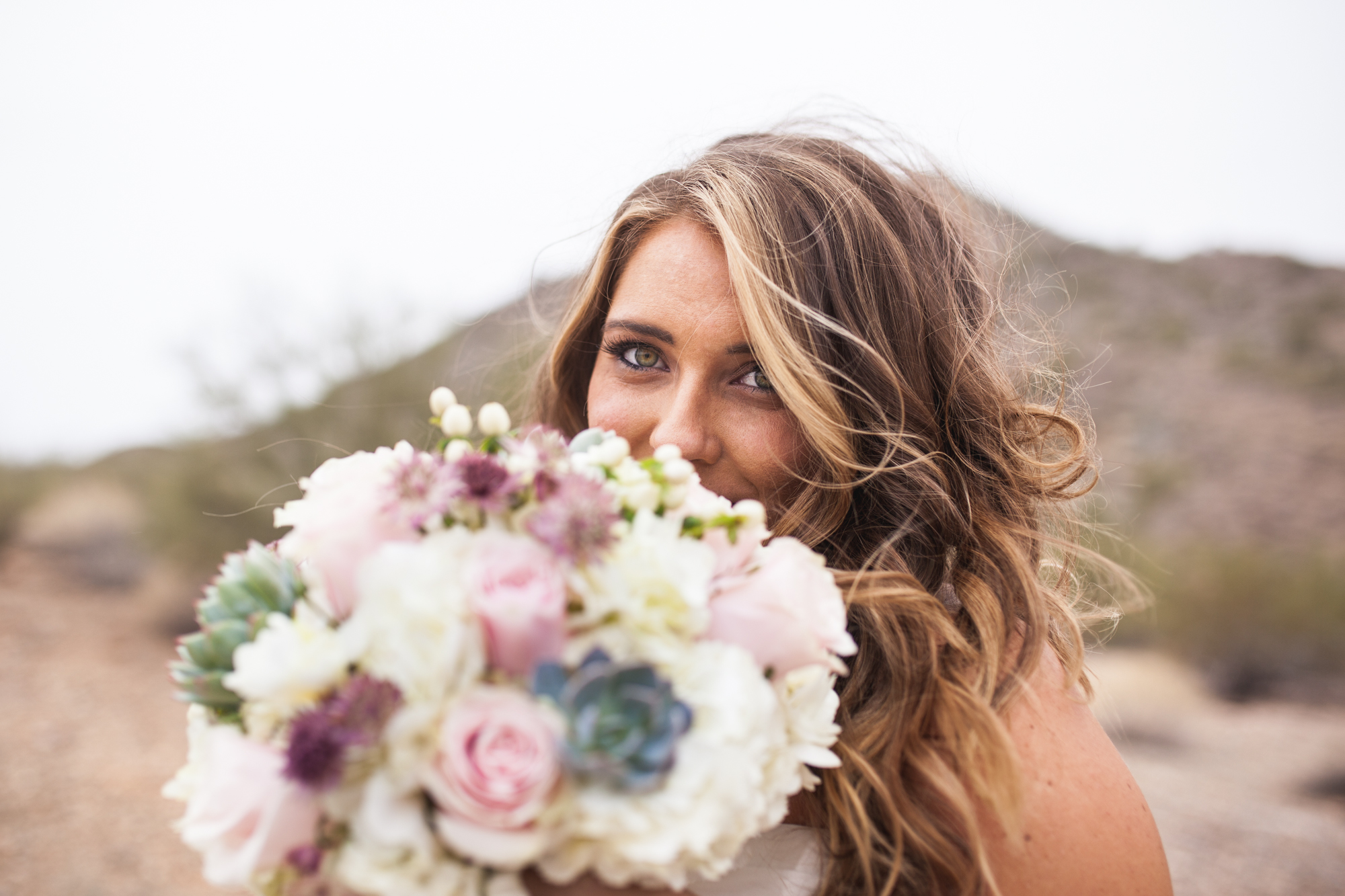 bride with succulent bridal bouquet with pink roses