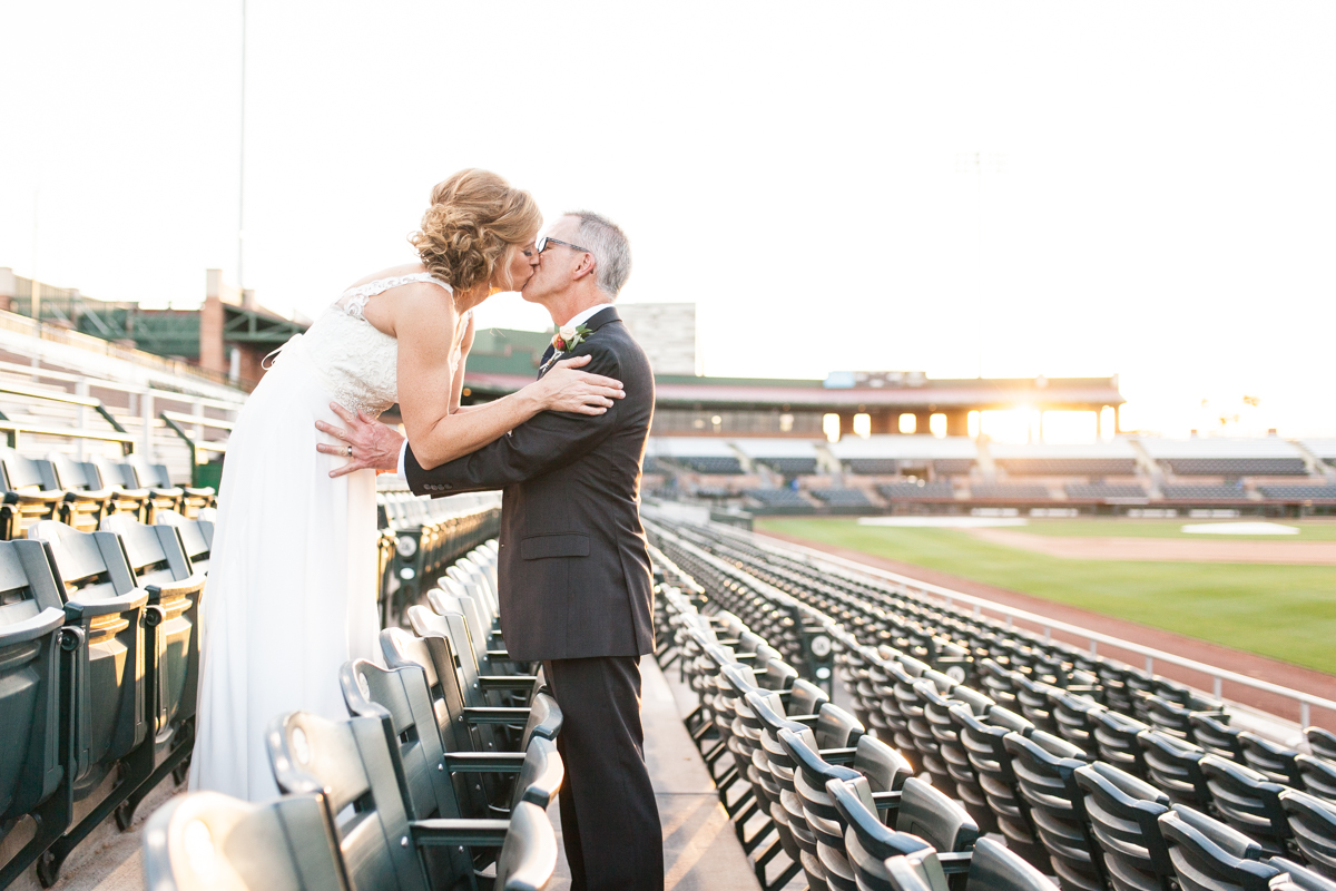 bride and groom in baseball stadium wedding