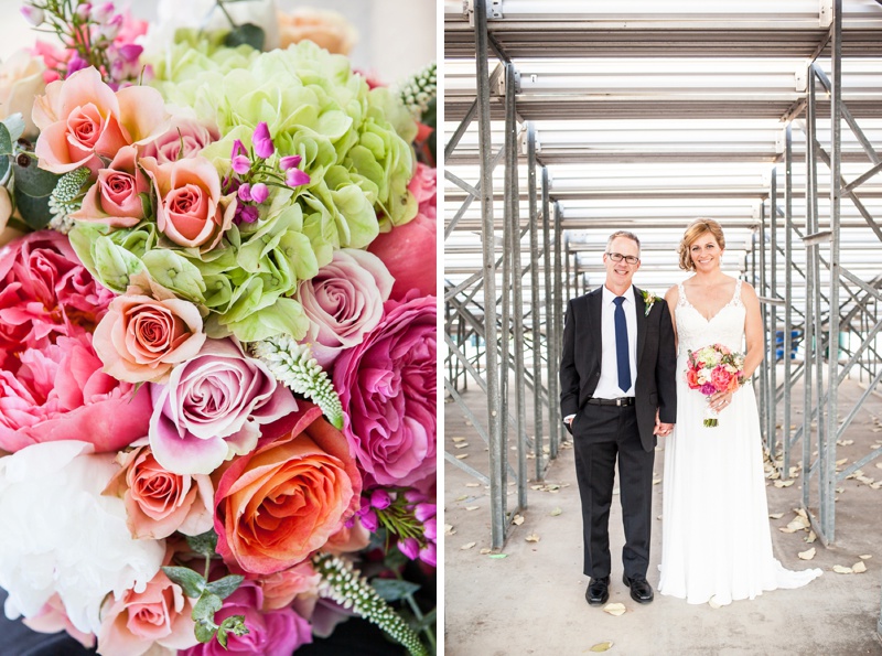 bride and groom behind bleachers at baseball wedding and colorful bouquet flowers
