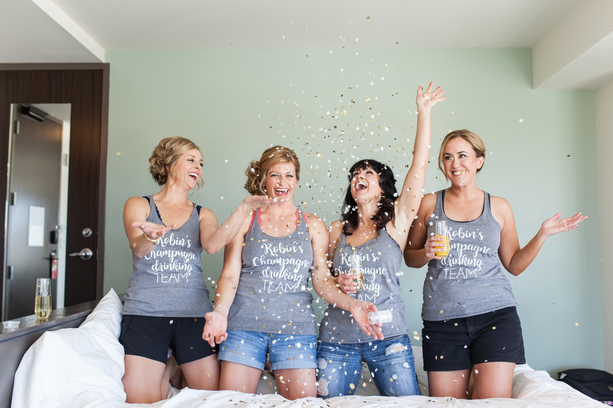 bride and bridesmaids throwing confetti on wedding day