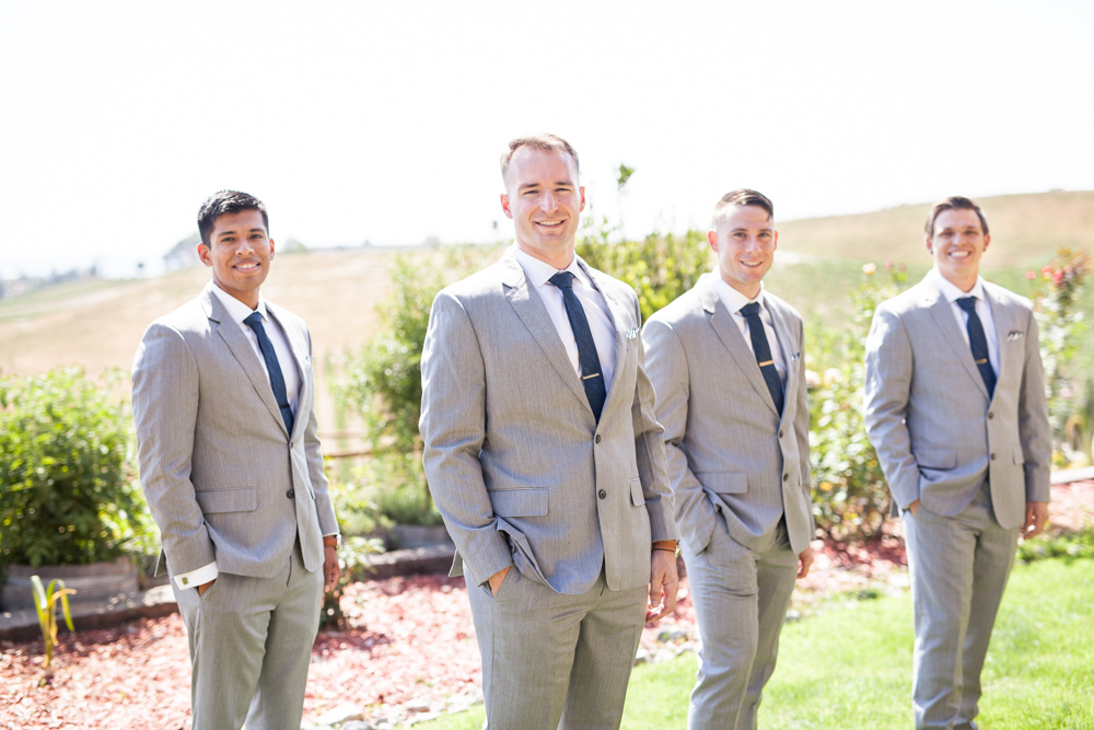 Groom and groomsmen in grey tuxedos