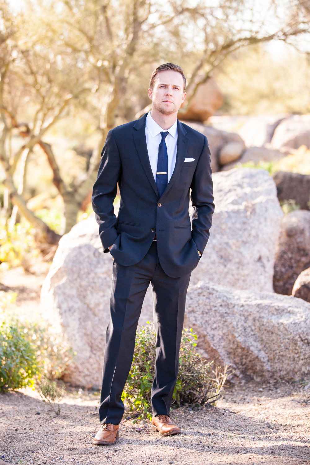 groom in black tux with navy blue tie