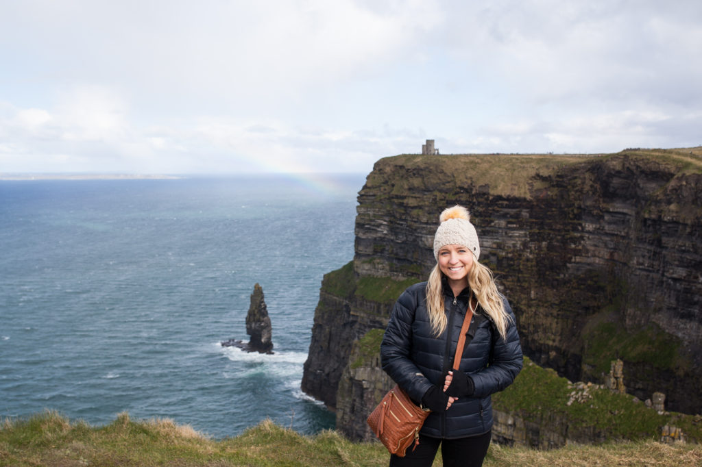 Brooke at the cliffs of Moher with rainbow