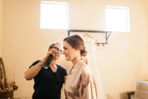 bride getting hair done for wedding day