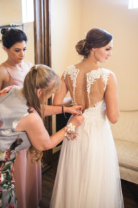 bride getting into her wedding dress