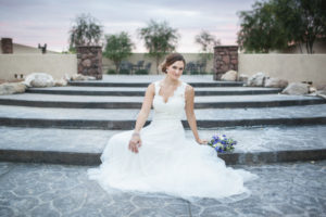 bride with v-neck a-line lace tattoo back wedding dress sitting on steps