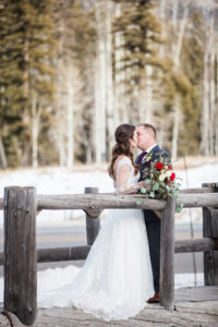 Durango, Colorado Winter Wedding, bride and groom kissing on a bridge