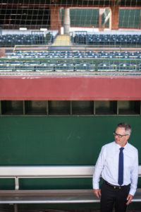 groom in dugout of baseball stadium