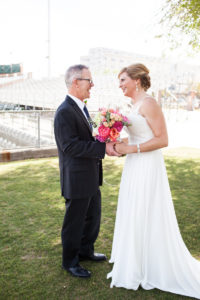 first look with bride and groom in baseball stadium