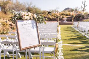 wedding ceremony florals on Welcome sign at desert ceremony