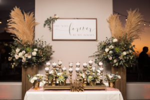 troon north wedding reception sweetheart table with candles and florals