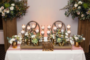 troon north wedding reception sweetheart table with candles and florals